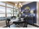Beautiful dining room with large windows, chandelier, blue accent wall, and stylish decor at 1005 Vesper Ct, Durham, NC 27703