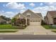 Beautiful home showcasing a landscaped front yard, attached garage, and a mix of stone and siding exterior at 1005 Vesper Ct, Durham, NC 27703