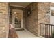 Welcoming front porch featuring stone detailing, a decorative sunburst accent, and seating at 1005 Vesper Ct, Durham, NC 27703