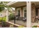 Inviting front porch with stone pillars, decorative shrubbery and furniture at 1005 Vesper Ct, Durham, NC 27703