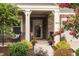 Charming front porch with stone accents, decorative plants, and a cozy seating area at 1005 Vesper Ct, Durham, NC 27703