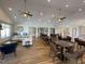 Well-lit lounge area featuring a cozy couch and several tables and chairs at 1005 Vesper Ct, Durham, NC 27703