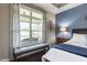 This primary bedroom has a large window with a bench that overlooks the patio at 1005 Vesper Ct, Durham, NC 27703