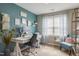This office space features teal accent walls, a large window, and unique decorations that brighten up the space at 1005 Vesper Ct, Durham, NC 27703