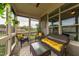 Comfortable screened-in porch with wicker furniture and scenic backyard views at 1005 Vesper Ct, Durham, NC 27703