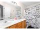 Bathroom featuring double sinks, wooden cabinets, large mirror and fun video game themed shower curtain at 101 Elk River Ct. Ct, Mebane, NC 27302