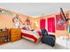 Sports themed bedroom with a bed, dresser, tv, chair, and murals of athletes on the walls at 101 Elk River Ct. Ct, Mebane, NC 27302