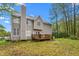 Exterior of house, showcasing a backyard with a wooden deck surrounded by lush green grass and trees at 101 Elk River Ct. Ct, Mebane, NC 27302