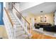 Bright living room adjacent to staircase features hardwood floors and neutral wall colors at 101 Elk River Ct. Ct, Mebane, NC 27302