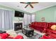 Cozy living room with a fireplace, large TV, and comfortable red leather furniture at 101 Elk River Ct. Ct, Mebane, NC 27302