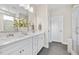 Modern bathroom featuring a double vanity, sleek fixtures, and a glass-enclosed shower at 102 E Star Foal Ln, Wendell, NC 27591