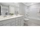 Bathroom featuring dual sinks, white cabinets, and a shower-tub combo at 102 E Star Foal Ln, Wendell, NC 27591
