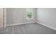 Bedroom with carpeted floors and a window offering a view of the lush, green outdoors at 102 E Star Foal Ln, Wendell, NC 27591