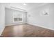 Bedroom with neutral walls, hardwood floors, large windows, and tray ceilings at 102 E Star Foal Ln, Wendell, NC 27591
