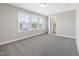 Well-lit bedroom with carpet and access to the ensuite bathroom through a doorway at 102 E Star Foal Ln, Wendell, NC 27591