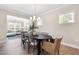 Dining area featuring a large table, modern chandelier, and open view to the living room at 102 E Star Foal Ln, Wendell, NC 27591