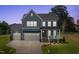 Charming two-story home showcasing a manicured lawn, a two-car garage and welcoming front porch at 102 E Star Foal Ln, Wendell, NC 27591