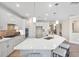 Modern kitchen with a large island, quartz countertops, and barstool seating area at 102 E Star Foal Ln, Wendell, NC 27591
