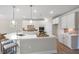 Bright kitchen showcasing an oversized island, stainless steel appliances, and white cabinetry at 102 E Star Foal Ln, Wendell, NC 27591