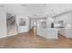 Open-concept living space featuring a modern kitchen, hardwood floors, and staircase at 102 E Star Foal Ln, Wendell, NC 27591