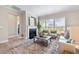 Cozy living room with a fireplace, large windows, and comfortable seating arrangements at 102 E Star Foal Ln, Wendell, NC 27591