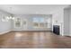 Bright living room with hardwood floors, a fireplace, large windows, and a back door at 102 E Star Foal Ln, Wendell, NC 27591