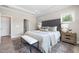 Comfortable main bedroom with a stylish upholstered headboard and ample natural light at 102 E Star Foal Ln, Wendell, NC 27591