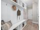 Well-organized mudroom with built-in bench, storage shelves, hooks, and decorative accents. Offers practical entryway solution at 102 E Star Foal Ln, Wendell, NC 27591