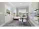 Bright sun room features large windows, neutral decor, and a stylish rug creating a relaxing atmosphere at 102 E Star Foal Ln, Wendell, NC 27591
