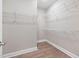 A large walk-in closet with white wire shelving and luxury vinyl flooring at 102 E Star Foal Ln, Wendell, NC 27591