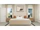 Bright bedroom features large windows, and a comfortable bed with stylish pillows and lamps at 103 Ellsworth Ct # 175, Garner, NC 27529