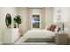 Serene bedroom with a gray upholstered bed, natural light, and cozy accents at 103 Ellsworth Ct # 175, Garner, NC 27529