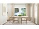 Bright dining room with table for six, large windows and neutral tones throughout at 103 Ellsworth Ct # 175, Garner, NC 27529