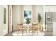 Bright dining room features a white table, six chairs, and natural light from the large windows at 103 Ellsworth Ct # 175, Garner, NC 27529