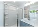 Well-lit bathroom featuring a glass shower, sleek vanity, and a large mirror at 1047 |1049 E Harnett St, Dunn, NC 28334