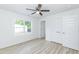 Bright bedroom featuring wood laminate floors and a closet with paneled doors at 1047 |1049 E Harnett St, Dunn, NC 28334