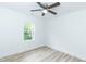 Bright bedroom with light-tone laminate flooring and white walls complemented by a ceiling fan at 1047 |1049 E Harnett St, Dunn, NC 28334