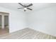 Bright bedroom with light-tone wood flooring and ceiling fan at 1047 |1049 E Harnett St, Dunn, NC 28334