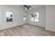 Bedroom featuring two windows and light wood-look flooring at 1047 |1049 E Harnett St, Dunn, NC 28334