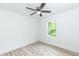 Bright bedroom with light-tone laminate flooring and white walls complemented by a ceiling fan at 1047 |1049 E Harnett St, Dunn, NC 28334