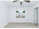 Bright bedroom with white walls, light-tone laminate flooring, and a ceiling fan at 1047 |1049 E Harnett St, Dunn, NC 28334