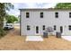 Back of a two-story house with gray siding, multiple windows, and a patio at 1047 |1049 E Harnett St, Dunn, NC 28334