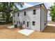Two-story house exterior with gray siding, white trim, and a concrete patio area at 1047 |1049 E Harnett St, Dunn, NC 28334