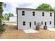 Two-story house exterior with gray siding, white trim, and concrete patio at 1047 |1049 E Harnett St, Dunn, NC 28334