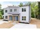 Attractive gray duplex with new landscaping, covered entryway with wood columns, and inviting blue doors at 1047 |1049 E Harnett St, Dunn, NC 28334