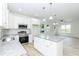 Bright kitchen and eating area with white cabinets, stainless appliances, and granite countertops at 1047 |1049 E Harnett St, Dunn, NC 28334