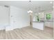 Bright open kitchen and eating area with stylish island and modern lighting at 1047 |1049 E Harnett St, Dunn, NC 28334