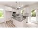 A kitchen with an island, granite countertops, stainless steel appliances, and white cabinetry at 1047 |1049 E Harnett St, Dunn, NC 28334