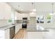 Stylish kitchen with white cabinets, stainless appliances, and granite countertops at 1047 |1049 E Harnett St, Dunn, NC 28334