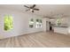 Bright open-concept area with wood-look flooring seamlessly connecting the living room and modern white kitchen at 1047 |1049 E Harnett St, Dunn, NC 28334